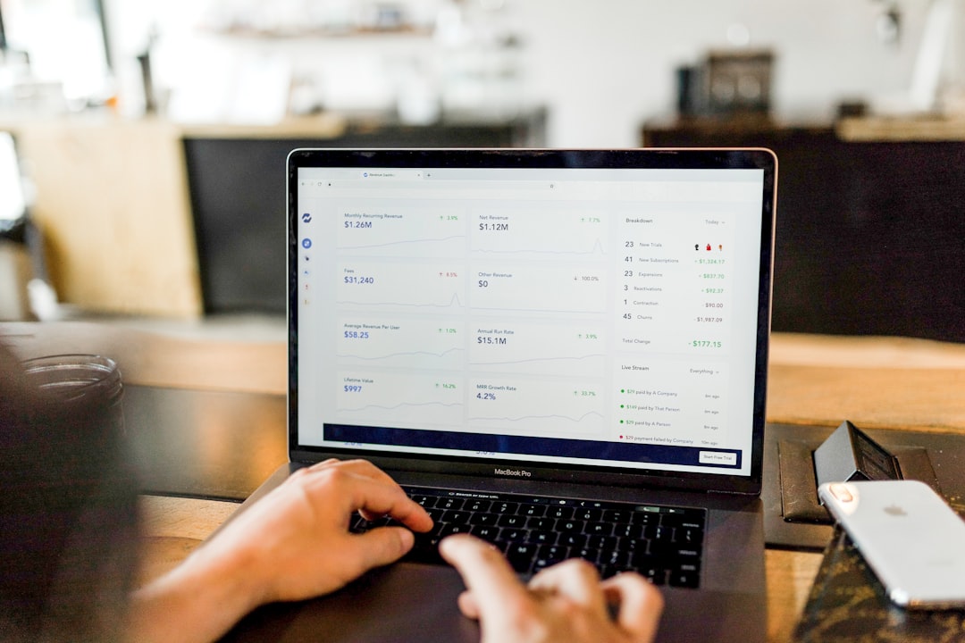 A person sits comfortably at a desk, browsing online real estate listings on a laptop, illustrating the digital-first approach to finding a new home in Memphis.