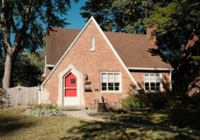 Beautiful single-family brick home with a green lawn and excellent curb appeal, representing a smart real estate investmen...